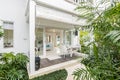 Unique patio area with wooden furniture surrounded by a garden.