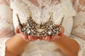 image of beautiful lady with white lace dress holding diamond crown. fantasy medieval period. Royalty Free Stock Photo