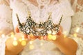 image of beautiful lady with white lace dress holding diamond crown. fantasy medieval period. Royalty Free Stock Photo