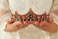 image of beautiful lady with white lace dress holding diamond crown. fantasy medieval period. Royalty Free Stock Photo