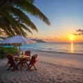 Image of Beautiful panoramic nature. Tropical beach sunset as summer island landscape with chairs umbrella palm leaves Royalty Free Stock Photo