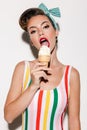 Beautiful pin up woman eating ice cream. Royalty Free Stock Photo