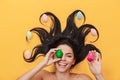 Pleased happy young woman lies isolated on yellow background over easter eggs Royalty Free Stock Photo