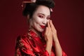Image of beautiful shy geisha woman in traditional japanese kimono smiling Royalty Free Stock Photo