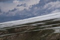 winter landscape snow-covered mountain slope highland canyon landform gray clouds Royalty Free Stock Photo