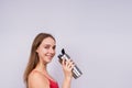 Image of beautiful strong happy cheerful young sports woman posing isolated indoors drinking water. Royalty Free Stock Photo