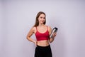 Image of beautiful strong happy cheerful young sports woman posing isolated indoors drinking water. Royalty Free Stock Photo