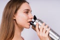 Image of beautiful strong happy cheerful young sports woman posing isolated indoors drinking water. Royalty Free Stock Photo