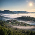 Beautiful summer scenery. Morning fog spreads on the mountain valley. Panoramic summer scene of Carpathian village. Royalty Free Stock Photo