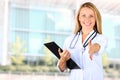 Image of beautiful woman doctor looking at camera and giving a hand Royalty Free Stock Photo