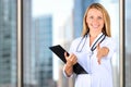 Image of beautiful woman doctor looking at camera and giving a hand Royalty Free Stock Photo