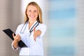 Image of beautiful woman doctor looking at camera and giving a hand Royalty Free Stock Photo