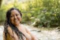 Head shot portrait of a Chubby Mexican woman smiling at the camera with green vegetation Royalty Free Stock Photo