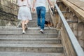 Image of beautiful young couple smiling and holding hands together while walking down city stairs Royalty Free Stock Photo