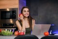 Image of a beautiful young student girl with apple sitting indoors using laptop computer. Royalty Free Stock Photo