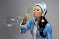 Image of beauty snow maiden blowing soap bubble