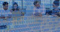 Image of binary coding and data processing over business people working in office Royalty Free Stock Photo
