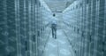 Image of binary coding numbers changing over man in tech room with computer servers Royalty Free Stock Photo