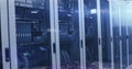 Image of binary coding numbers changing over tech room with computer servers Royalty Free Stock Photo
