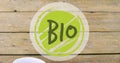 Image of bio text banner against bowl of fruit salad on wooden table Royalty Free Stock Photo