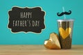 Image of black cup with golden heart. Father`s day concept. Royalty Free Stock Photo