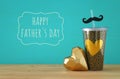 Image of black cup with golden heart. Father`s day concept. Royalty Free Stock Photo