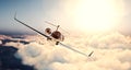 Image of black luxury generic design private jet flying in blue sky at sunset. Huge white clouds and sun background Royalty Free Stock Photo