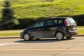 Speeding black minivan in motion Royalty Free Stock Photo