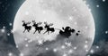 Image of black silhouette on santa claus in sleigh being pulled by reindeer with winter scenery Royalty Free Stock Photo