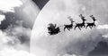 Image of black silhouette on santa claus in sleigh being pulled by reindeer with winter scenery Royalty Free Stock Photo