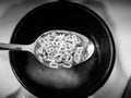 Image of black and white alphabet noodels soup with spoon Royalty Free Stock Photo