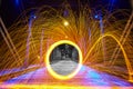 Black and white middle portal with a yellow circle of sparks on a bridge at night Royalty Free Stock Photo