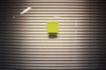 Image of blank sticky note on office glass wall with jalousie