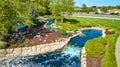 Blue creek river waterfall landscaping for neighborhood entrance professional cross cut of grass Royalty Free Stock Photo