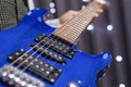 Image of a blue electric guitar close-up. The concept of tuning and repairing musical instruments