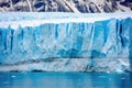 image of a blue-hued glacier just before a calving incident