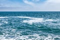 Blue sea with waves and sky with clouds Royalty Free Stock Photo