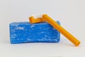 Blue Washing Soap and Orange Shaving Razor on Gray Background
