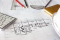 Image of blueprints with level pencil and hard hat on table Royalty Free Stock Photo