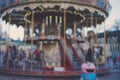 blur street with festive lights and carousel in night time. Blur bokeh light defocused background Royalty Free Stock Photo