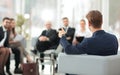 Image is blurred.businessman conducting a meeting