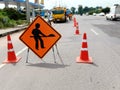 The image is blurred in road maintenance work and there is a warning sign for the construction work Royalty Free Stock Photo