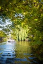 Boat on canal seen through the trees in Amsterdam Royalty Free Stock Photo