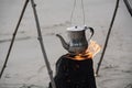 boiling water kettle on wood campfire by beach. Royalty Free Stock Photo