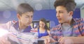 Image of bokeh over two male students using smartphone at school Royalty Free Stock Photo