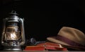 Image of book lamp hat dark background