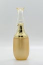 Image of a bottle of golden perfume.