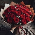 an image bouquet of many Red roses in wrapping paper.