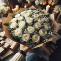 an image bouquet of many white roses in wrapping paper.