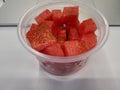 Image of a bowl with chopped watermelon on a desk in the office Royalty Free Stock Photo
